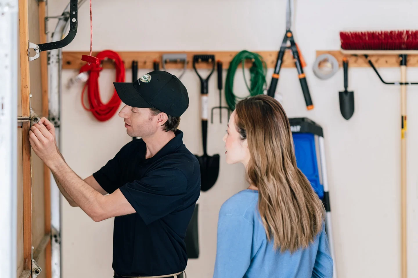 Precision technician inspecting a garage door
